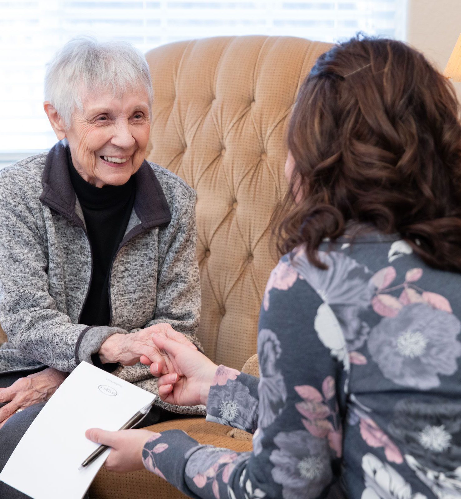 TM-WI-People-0538 Team member holding hand of smiling resident.